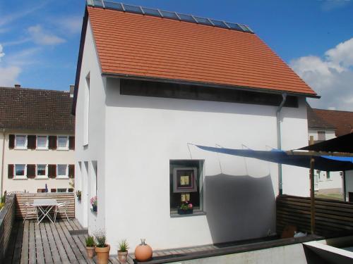 a white building with a red roof and a patio at Holiday Home Albergo Centro by Interhome in Hüfingen