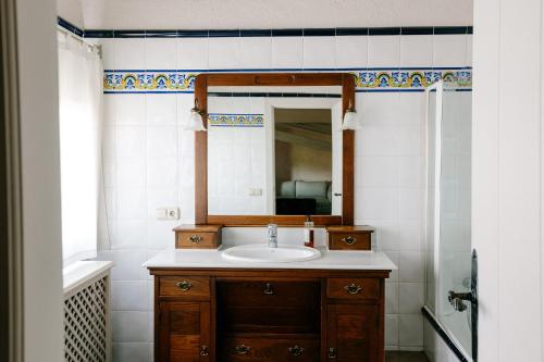 a bathroom with a sink and a mirror at Hotel Finca El Peregrino in Puente la Reina