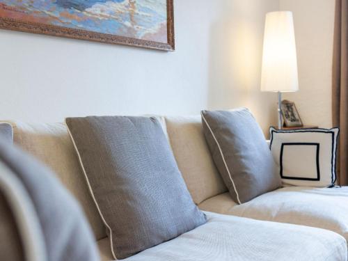 a couch with pillows in a living room at Holiday Home Dumont by Interhome in Manno