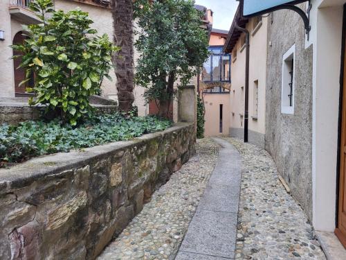 an alley in an old town with a stone wall at Holiday Home Dumont by Interhome in Manno