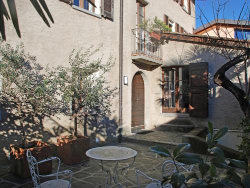 a patio with a table and chairs in front of a building at Holiday Home Dumont by Interhome in Manno