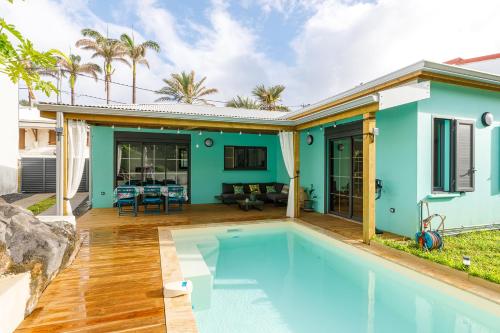 a swimming pool in front of a house at maison de vacances Althéa in Saint-Pierre