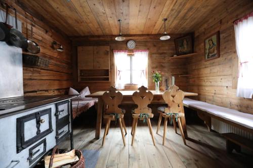 a kitchen with a table and two chairs in a cabin at Almhütte Oberschaller bei Alfenalm - Ferienwohnungen am Berg in Innervillgraten