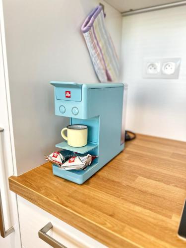 a blue coffee maker sitting on top of a counter at CITY Apartment II in Trenčín