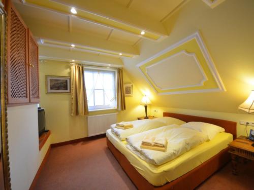 a bedroom with a large bed and a window at Holiday Home Kirchhaus by Interhome in Groß Zicker