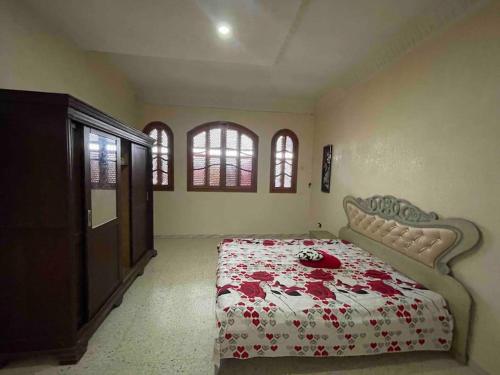 a bedroom with a bed with red flowers on it at Apartment with amazing view in Bizerte