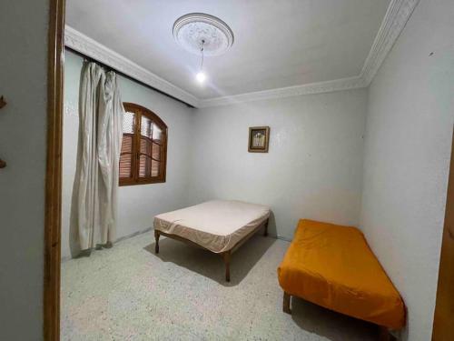a small room with a bed and a window at Apartment with amazing view in Bizerte