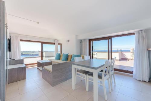 a living room with a table and a couch at Aparthotel Caprice Skyline in Ciutadella