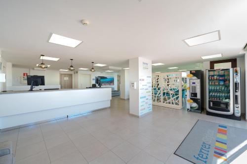 a pharmacy lobby with a counter and vending machines at Aparthotel Caprice Skyline in Ciutadella