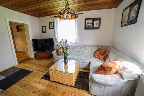 a living room with a couch and a table at Pension Arberwald in Bayerisch Eisenstein