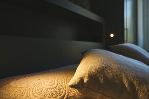 a close up of a bed with a pillow on it at Villa Margherita in Levanto