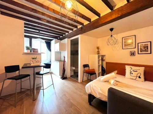 une chambre avec un lit, une table et des chaises dans l'établissement Le Chalotais, Hyper centre de Rennes, à Rennes