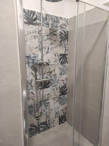 a shower with a glass door in a bathroom at a CASA DI PAPY in Lido Conchiglie