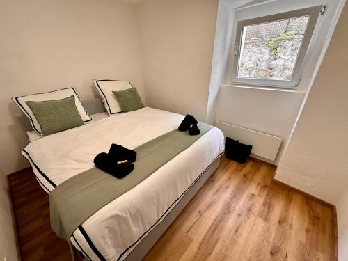 a bedroom with a bed with two black objects on it at Schöne Ferienwohnung in Schottwien