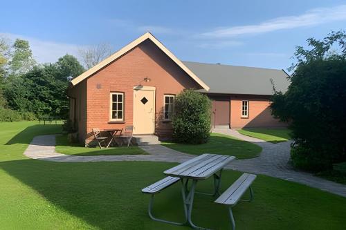 a house with a picnic bench in front of it at Vingårdens Bed & Breakfast in Helsingborg