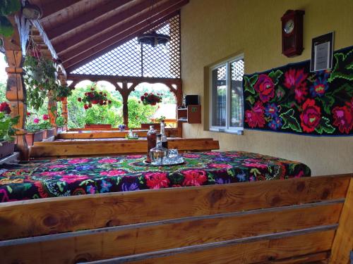 a bedroom with a bed with a table in it at Pensiunea Maramu in Breb
