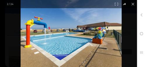 an image of a swimming pool with a water slide at Crandley Manor Lodge in Whitstable