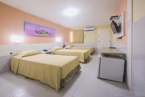 Hotel Pousada Tamandaré - PB tesisinde bir odada yatak veya yataklar