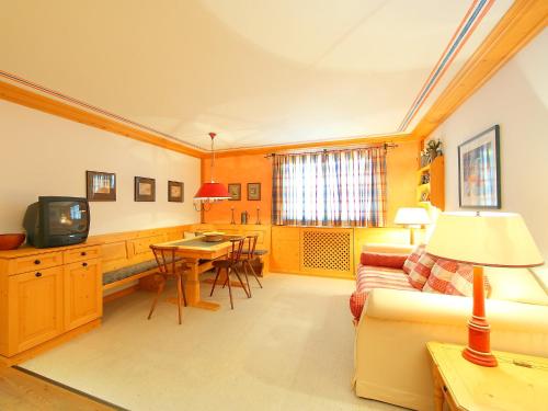 a living room with a couch and a table at Apartment Residenza Chesa Margun 57-4 by Interhome in Surlej