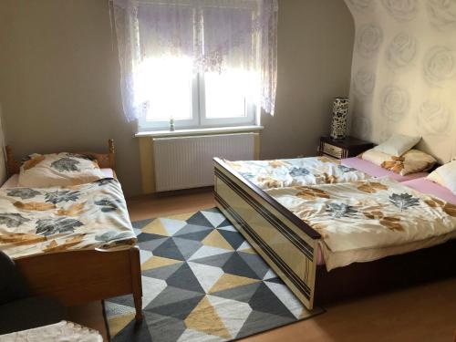 Posteľ alebo postele v izbe v ubytovaní Dom pod barankiem