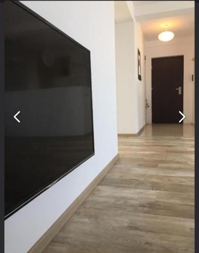 a large flat screen tv on a wall in a hallway at 4 RENT-Apt 3 camere Tichete,Factură in Constanţa