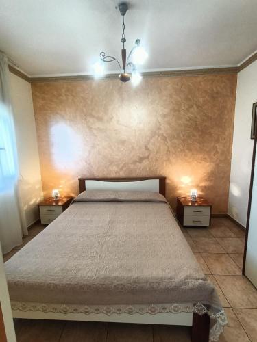 a bedroom with a large bed with two night stands at Apartment Girasole in Acquedolci