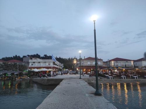 a street light next to a body of water at Happy Home in Agia Triada