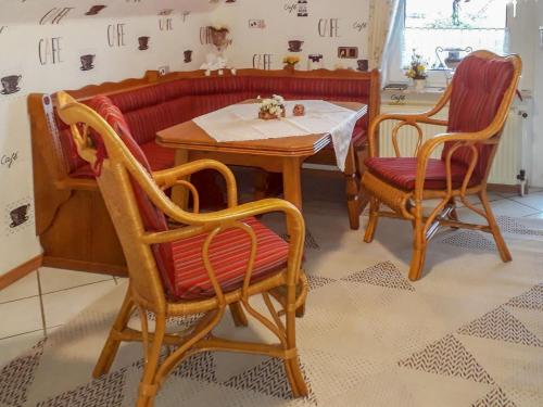 a table and two chairs and a table and a table at Apartment Daija by Interhome in Pewsum