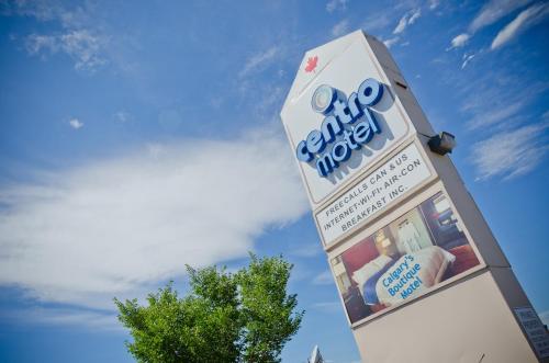 a sign for a store with a sky in the background at Centro Motel in Calgary