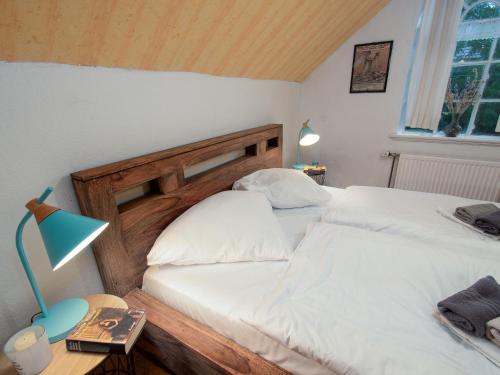 a bedroom with two white beds and a desk with a lamp at Holiday Home Itzendorfer Rott-2 by Interhome in Norddeich