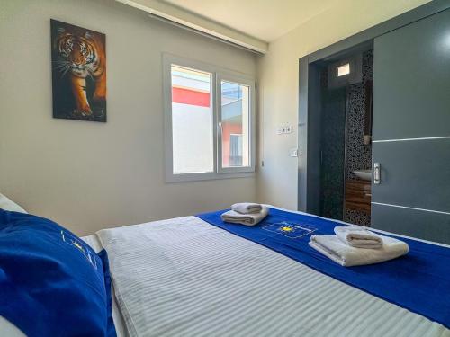 a bedroom with a bed with towels on it at Exclusive Villas in Kusadası
