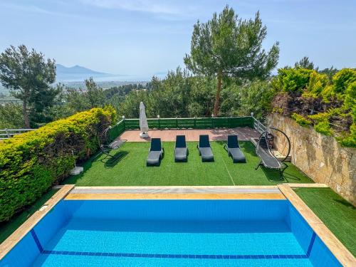 a swimming pool with a lawnarmaarmaarmaarmaarmaarmaarmaarmaarmaarma at Exclusive Villas in Kusadası