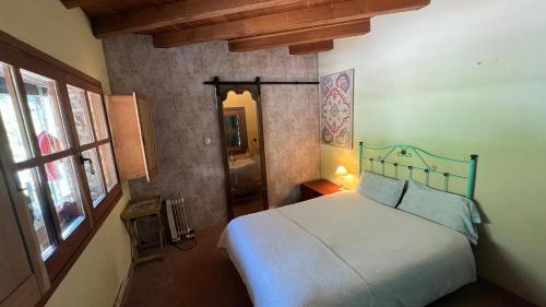 a bedroom with a white bed and a window at Bed&Breakfast la Cabanya de Beget in Beget