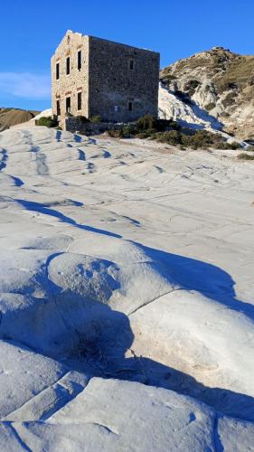an old building sitting on top of a snow covered hill at Casa Dolce Casa in Enna