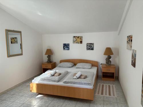 a bedroom with a bed and two night stands at Apartment Galeb Komarna in Komarna