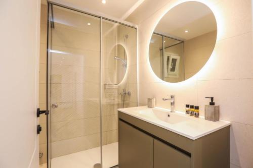 a bathroom with a sink and a shower at Patras Luxury Apartment in Corfu Town