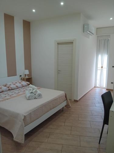 a bedroom with a bed and a table and a window at Vama House in Naples