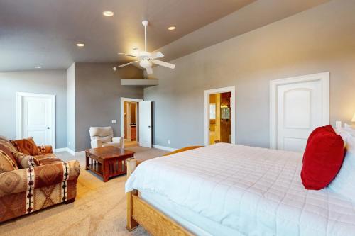 a bedroom with a white bed and a couch at Woodland Haven in South Lake Tahoe