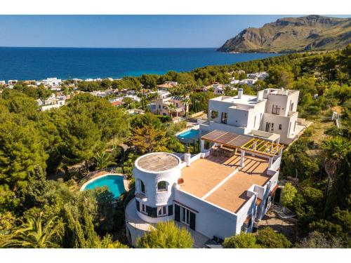 an aerial view of a large white house with the ocean at Villa Pinomar by Interhome in Colonia de Sant Pere