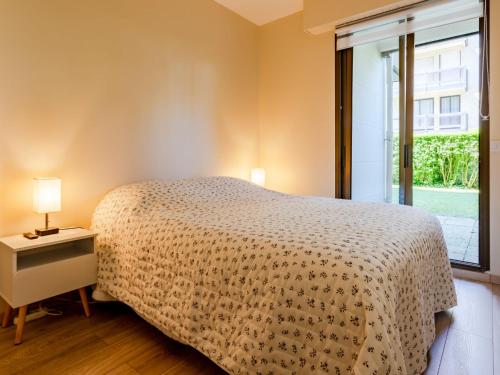 une chambre avec un lit et une grande fenêtre dans l'établissement Apartment La Commanderie by Interhome, à Deauville