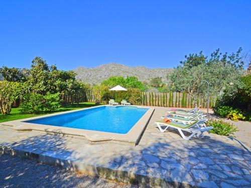 a swimming pool with two lounge chairs next to it at Holiday Home Cuxach d'en Joan by Interhome in Pollença