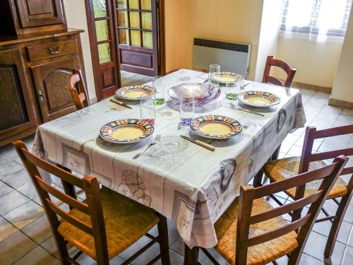 a dining room table with plates and glasses on it at Holiday Home Le Champ du Lac by Interhome in Salviac