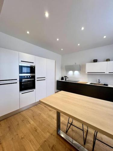 une grande cuisine avec une table en bois. dans l'établissement Villa Eden - 9 pers, à Charleville-Mézières