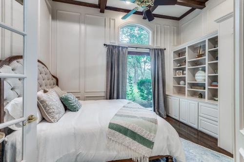 a bedroom with a bed and a window at 4-BR Waterfront - Pool Kayak Paddleboard & More in Lakewood Village