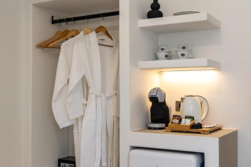 a white robe hanging on a rack in a room at Pergola in Pollonia