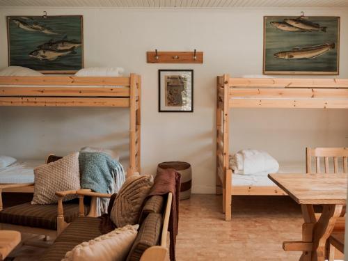 a room with two bunk beds and a table at Off the grid in the abandoned village of Ejheden in Voxnabruk