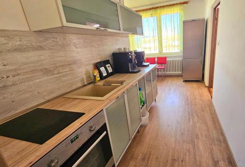 a kitchen with a sink and a counter top at Apartman RELAX in Trenčín