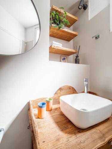 a bathroom with a white sink and a mirror at The Cottage in Petrití