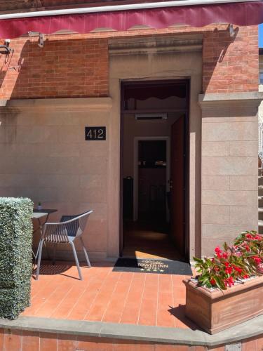 a door to a building with a bench and a table at Villa Tower Inn in Pisa