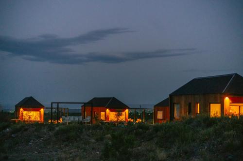a group of houses in a field at night at La Morada Lodge - Valle de Uco in Vista Flores